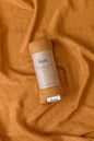 Organic muslin baby swaddle in caramel
soft newborn essential and baby shower gift. 
Breathable organic cotton bamboo swaddle for hospital bags and newborn sleep.